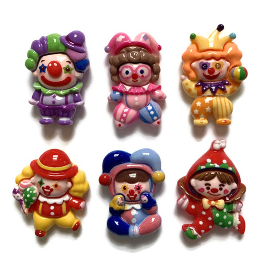 Six colorful clown magnets on a white background