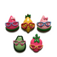 Five large fruit magnets on white background, including dark pink watermelon, yellow lemon, light pink watermelon, green avocado, and dark pink strawberry. All fruit are wearing eyeglasses.