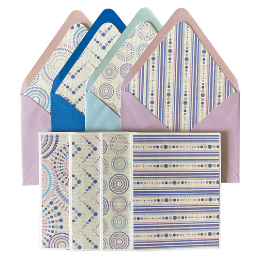 A collection of purple-toned lined envelopes and blank note cards with geometric patterns.
